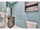 Half bathroom with nice vanity and modern fixtures with cool blue walls at 100 Bluff View Dr # 510A, Belleair Bluffs, FL 33770
