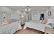 Spacious bedroom featuring two beds, light wood floors, and decor at 100 Bluff View Dr # 510A, Belleair Bluffs, FL 33770