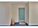 Entrance to Unit 510 featuring a blue door with a star decoration and blue carpeting at 100 Bluff View Dr # 510A, Belleair Bluffs, FL 33770