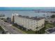 Exterior view showcasing a waterfront condo building with meticulous landscaping, parking and access to the water at 100 Bluff View Dr # 510A, Belleair Bluffs, FL 33770