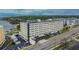 Exterior of a modern, multi-story condo building with clean lines, landscaping, and ample parking at 100 Bluff View Dr # 510A, Belleair Bluffs, FL 33770