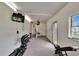 A spacious gym room with weights, a workout machine, and mounted TV at 100 Bluff View Dr # 510A, Belleair Bluffs, FL 33770