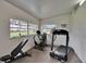Well-lit gym space with a treadmill, stationary bike, and weight bench at 100 Bluff View Dr # 510A, Belleair Bluffs, FL 33770