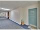 Hallway featuring brick accent wall, carpets, and Unit 510 with a painted blue door and star decoration at 100 Bluff View Dr # 510A, Belleair Bluffs, FL 33770