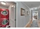 Hallway view with washer and dryer on the left, art on the wall, with bedroom at the end at 100 Bluff View Dr # 510A, Belleair Bluffs, FL 33770
