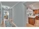 Inviting hallway featuring hardwood floors and stylish decor that leads to a lovely bedroom at 100 Bluff View Dr # 510A, Belleair Bluffs, FL 33770