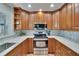 Charming kitchen featuring marble countertops, tiled backsplash and modern stainless steel appliances at 100 Bluff View Dr # 510A, Belleair Bluffs, FL 33770
