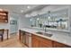 Updated kitchen featuring a breakfast bar with marble countertop and stainless steel dishwasher at 100 Bluff View Dr # 510A, Belleair Bluffs, FL 33770
