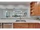 Bright kitchen featuring a breakfast bar with marble countertop and a view to the living room at 100 Bluff View Dr # 510A, Belleair Bluffs, FL 33770