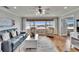 Bright living room with large windows overlooking the city and comfortable seating arrangement at 100 Bluff View Dr # 510A, Belleair Bluffs, FL 33770