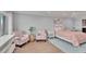 Comfortable main bedroom with lots of natural light, calming color palette, sitting area and en suite bathroom at 100 Bluff View Dr # 510A, Belleair Bluffs, FL 33770
