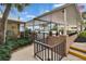 Pool entrance with covered walkway and black fence leading to an in-ground pool at 100 Bluff View Dr # 510A, Belleair Bluffs, FL 33770