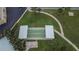 Aerial view of shuffleboard courts and patio area, surrounded by landscaping and manicured lawns at 100 Bluff View Dr # 510A, Belleair Bluffs, FL 33770