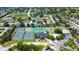 Aerial view of homes near community tennis courts and clubhouse, highlighting the community's amenities at 10035 82Nd St, Seminole, FL 33777