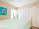 Bedroom featuring a bed, closet, and large window at 10035 82Nd St, Seminole, FL 33777