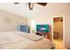 Bedroom features a king bed, ceiling fan, and access to a walk-in closet and bathroom at 10035 82Nd St, Seminole, FL 33777