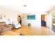 Spacious living room with hardwood floors, comfortable seating, and sliding door access at 10035 82Nd St, Seminole, FL 33777
