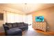 Cozy living room featuring a plush sofa, elegant chandelier, and stylish media cabinet at 10035 82Nd St, Seminole, FL 33777