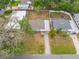 Aerial view of a single-story home featuring a long driveway, fenced backyard and mature trees at 1113 53Rd S St, Gulfport, FL 33707
