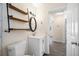 Well-lit bathroom featuring modern vanity, open shelving, and a sleek design at 1113 53Rd S St, Gulfport, FL 33707