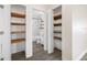 Bathroom with white tile, open shelves, and wood-look floors at 1113 53Rd S St, Gulfport, FL 33707