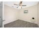Bedroom featuring gray wood-look floors, a ceiling fan, and a window overlooking the yard at 1113 53Rd S St, Gulfport, FL 33707