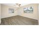 Bright bedroom with wood-look tile flooring, ceiling fan and natural light from two windows at 1113 53Rd S St, Gulfport, FL 33707