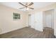 Bright bedroom with gray wood-look flooring, ceiling fan, and closet with double doors at 1113 53Rd S St, Gulfport, FL 33707