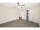 Inviting bedroom featuring a ceiling fan, tile flooring, and a closet with shelving at 1113 53Rd S St, Gulfport, FL 33707