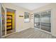 Dining area with wood-look floors and sliding doors to a porch with string lights at 1113 53Rd S St, Gulfport, FL 33707