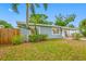 Inviting single-story home with a well-manicured front yard, mature trees, and a charming covered front porch at 1113 53Rd S St, Gulfport, FL 33707