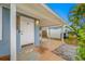 Charming front entrance featuring a covered porch with stylish lighting and a secure front door at 1113 53Rd S St, Gulfport, FL 33707