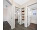 Hallway with storage shelves leads to a bedroom and a bathroom at 1113 53Rd S St, Gulfport, FL 33707