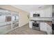 Open kitchen featuring stainless appliances, white cabinets and granite counters at 1113 53Rd S St, Gulfport, FL 33707