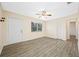 Bright living room with wood-look tile floors, closet, ceiling fan, and a large window at 1113 53Rd S St, Gulfport, FL 33707