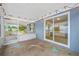Enclosed porch featuring sliding glass door with string lights creating a cozy space with views to the backyard at 1113 53Rd S St, Gulfport, FL 33707