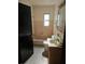 Bathroom features a tub with tile surround and a single sink vanity at 1125 Engman St, Clearwater, FL 33755