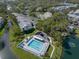 A high-angle view featuring a swimming pool, clubhouse, and the surrounding condo community at 11520 Shipwatch Dr # 1385, Largo, FL 33774