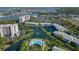 Aerial view of waterfront condos with a pool, tennis courts, and fountain at 11520 Shipwatch Dr # 1385, Largo, FL 33774