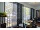 Bright enclosed balcony with large windows and an outdoor view complemented by a table and chairs at 11520 Shipwatch Dr # 1385, Largo, FL 33774