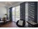 Enclosed balcony with sliding glass doors, modern window treatments, dining set, and comfortable chair at 11520 Shipwatch Dr # 1385, Largo, FL 33774
