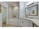 Bright bathroom featuring tiled shower-tub combo, vanity with white countertop, wood floors, and soft blue walls at 11520 Shipwatch Dr # 1385, Largo, FL 33774