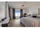 Bright bedroom featuring neutral walls, wood floors, desk, and a king size bed with nice curtains at 11520 Shipwatch Dr # 1385, Largo, FL 33774