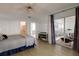 Bright bedroom with light wood floors, ceiling fan, and sliding glass doors to a screened lanai at 11520 Shipwatch Dr # 1385, Largo, FL 33774