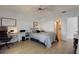 Bright bedroom with wood floors, neutral walls, a desk, a king bed and a ceiling fan at 11520 Shipwatch Dr # 1385, Largo, FL 33774