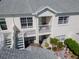 Aerial view of a multi-story building with balconies, staircases, and well-maintained landscaping at 11520 Shipwatch Dr # 1385, Largo, FL 33774