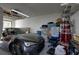 Garage interior with a parked car, storage shelves, a drum set, and assorted items at 11520 Shipwatch Dr # 1385, Largo, FL 33774