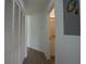 Hallway leads to bathroom with tiled walk-in shower and vanity at 11520 Shipwatch Dr # 1385, Largo, FL 33774