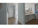 Clean hallway with modern finishes, leading to the kitchen and the front door, optimizing space and flow at 11520 Shipwatch Dr # 1385, Largo, FL 33774