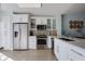 Contemporary kitchen with stainless steel appliances, white cabinetry, and ample counter space for cooking and entertaining at 11520 Shipwatch Dr # 1385, Largo, FL 33774